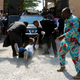 A man attempts to go under a Department of State Security (DSS) vehicle so to prevent Nigerian activist Omoyele Sowore’s re-arrest, outside the Federal High Court in Abuja, Nigeria Dec. 6, 2019.